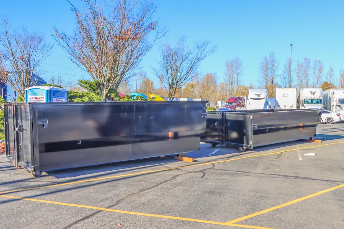 Professional dumpster rental service with roll-off container on residential driveway in Hapeville